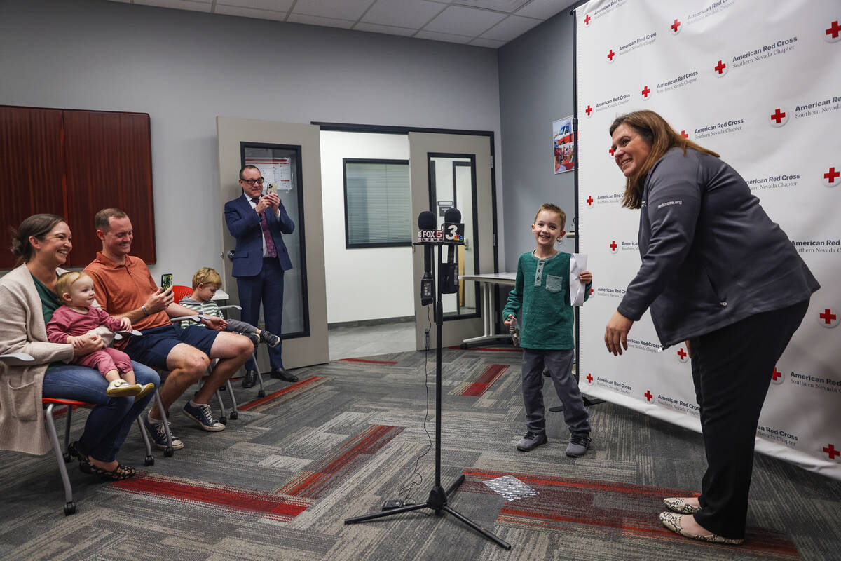 Henry Williams, 6, left, talks to Rachel Flanigan, executive director of the Red Cross of South ...