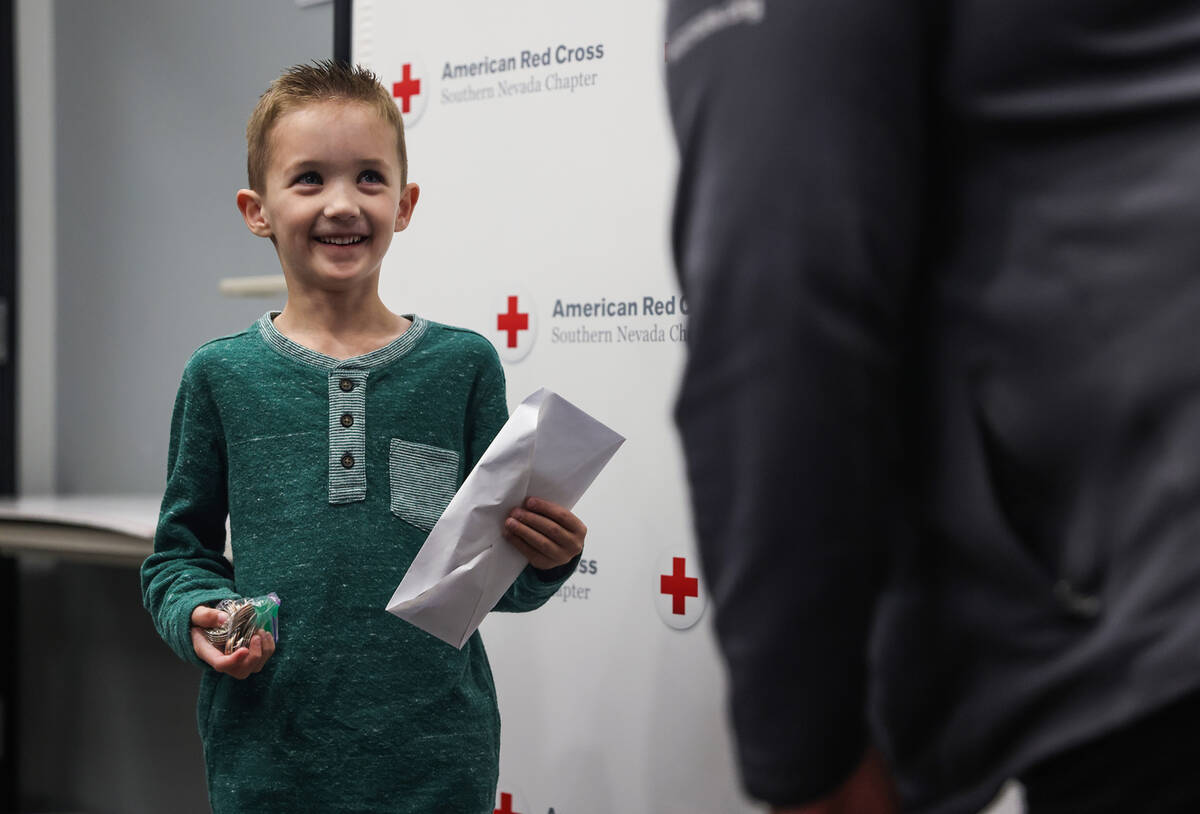 Henry Williams, 6, left, talks to Rachel Flanigan, executive director of the Red Cross of South ...