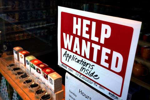 FILE - A help-wanted sign hangs in the front window of the Bar Harbor Tea Room, Saturday, June ...