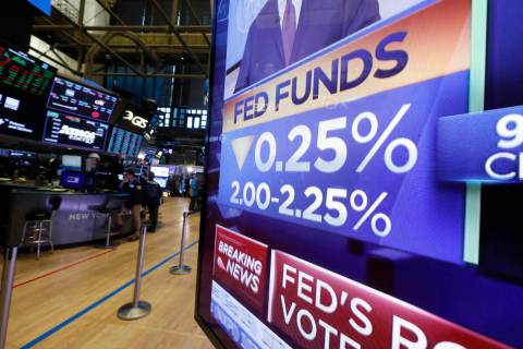 A television monitor on the floor of the New York Stock Exchange headlines the rate decision of ...