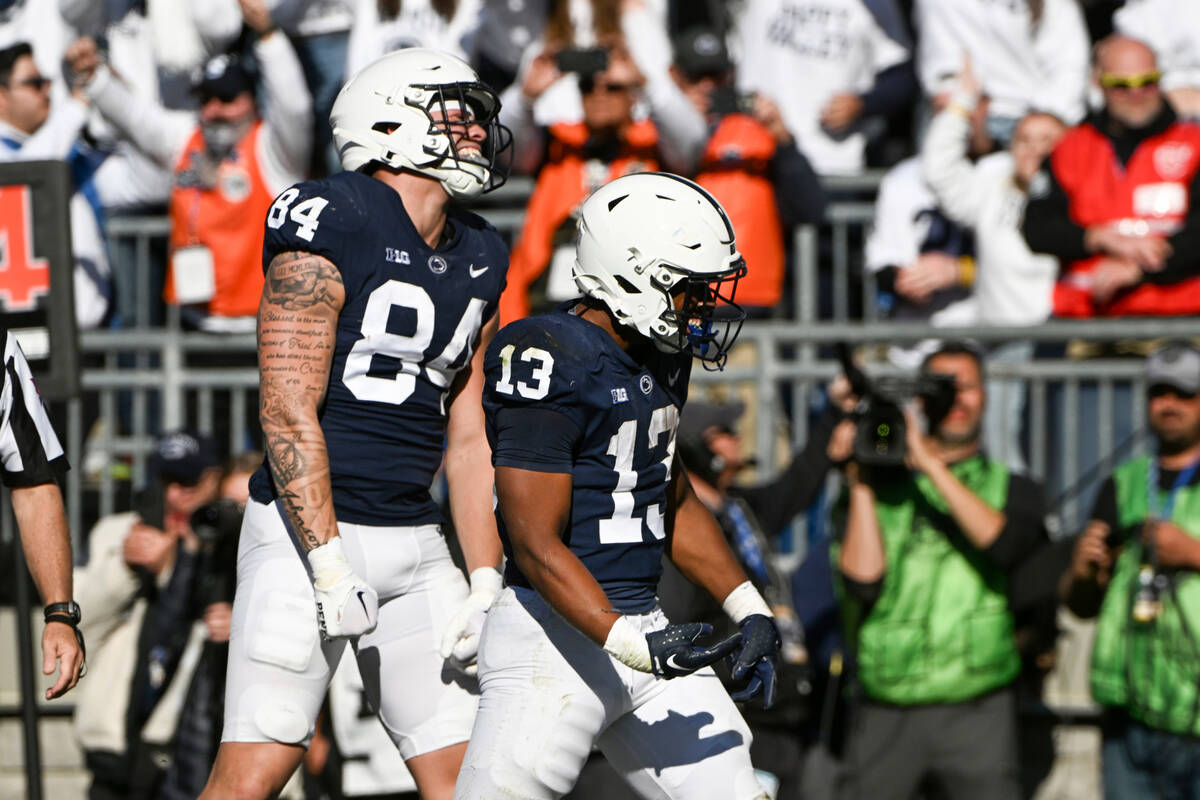 Penn State running back Kaytron Allen (13) and tight end Theo Johnson (84) celebrate a touchdow ...