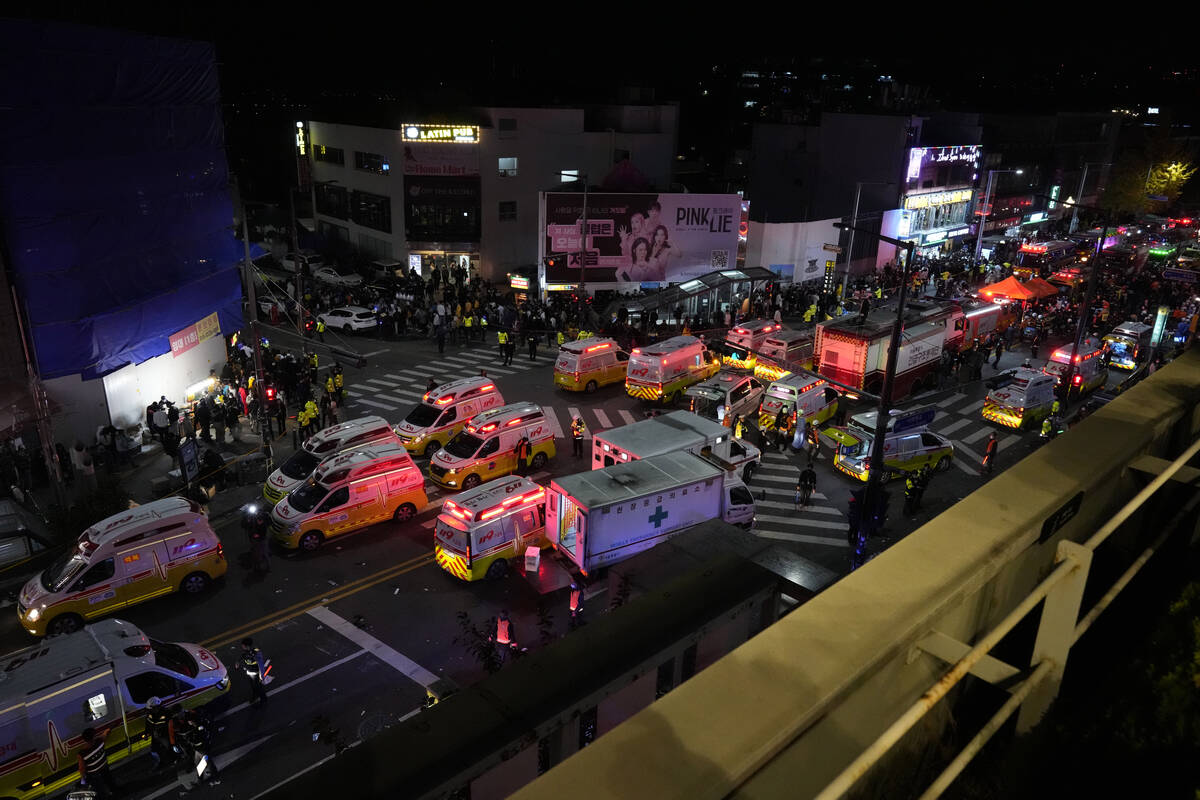 Ambulances and rescue workers arrive at the street near the scene in Seoul, South Korea, early ...