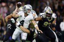 New Orleans Saints linebacker Kaden Elliss (55) tackles Las Vegas Raiders quarterback Derek Car ...