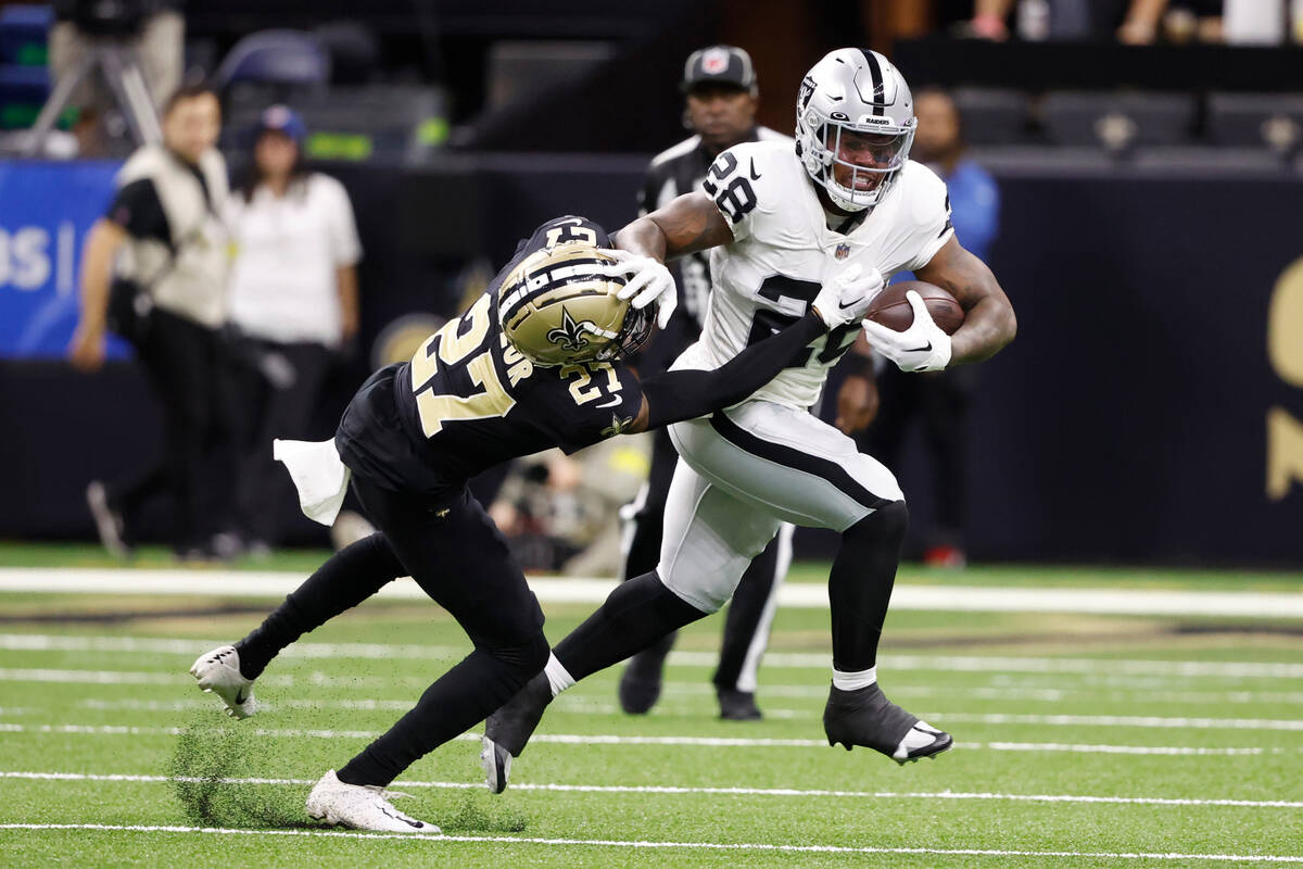 Las Vegas Raiders running back Josh Jacobs (28) runs against New Orleans Saints cornerback Alon ...