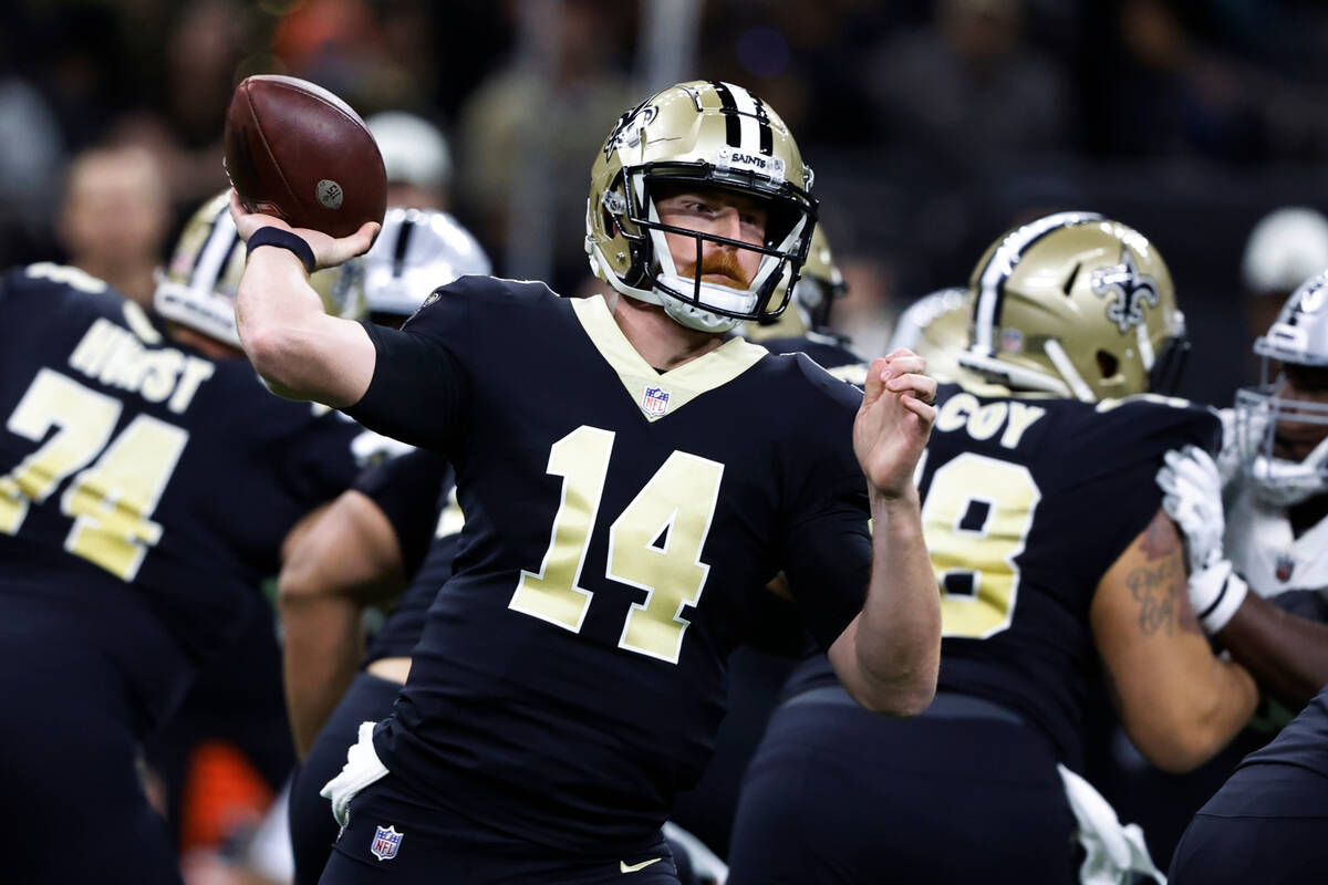 New Orleans Saints quarterback Andy Dalton (14) throws a pass during the first half of an NFL f ...