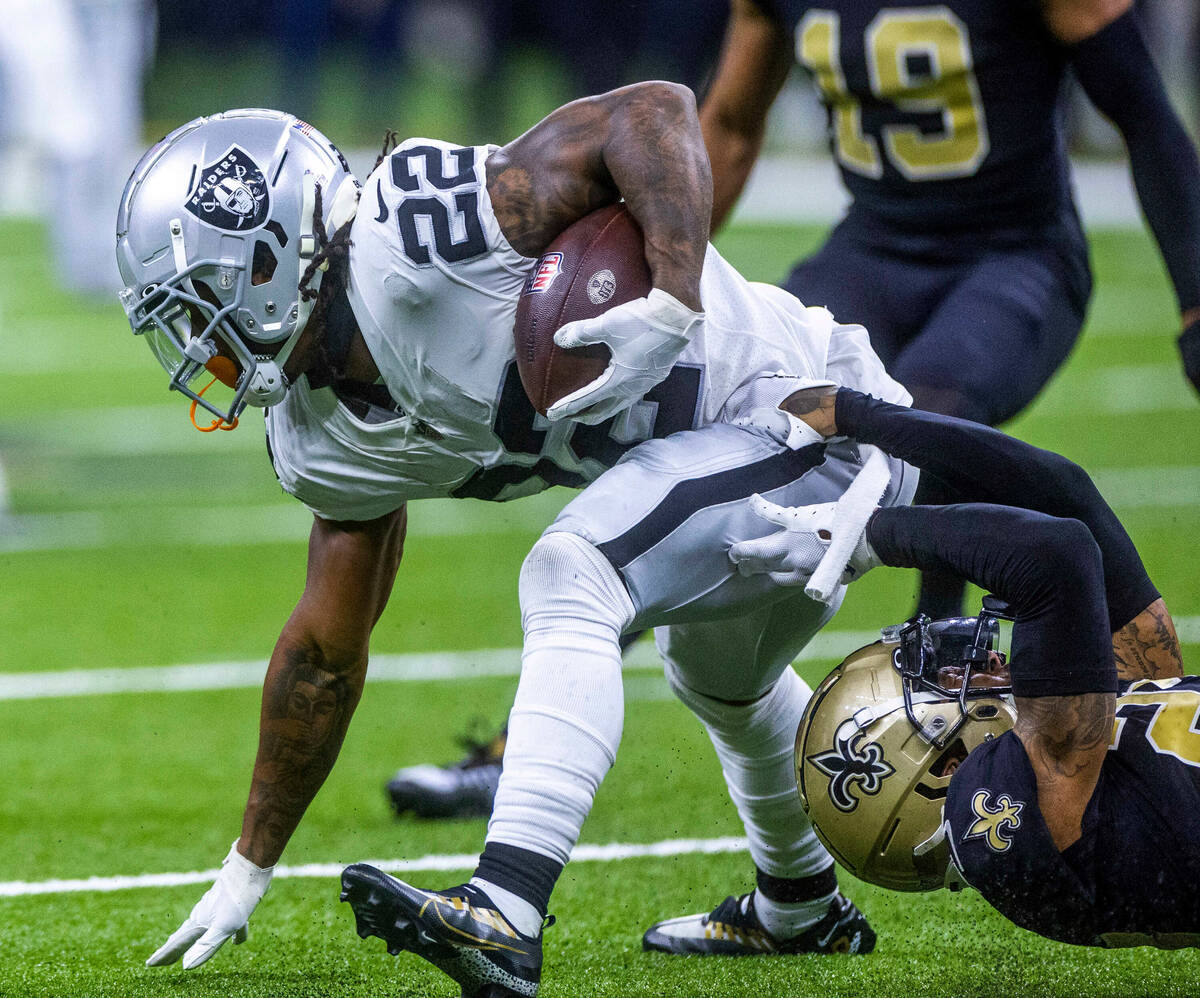 Raiders running back Ameer Abdullah (22) fights to break a tackle by New Orleans Saints cornerb ...