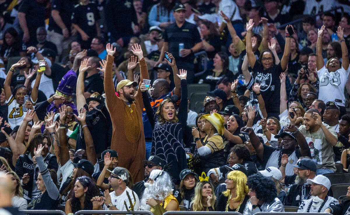 New Orleans Saints and Raiders fans have fun during the first half of their NFL game the Caesar ...