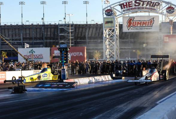 Brittany Force, left, races Mike Salinas, right, for the top fuel NHRA Nevada Nationals at the ...