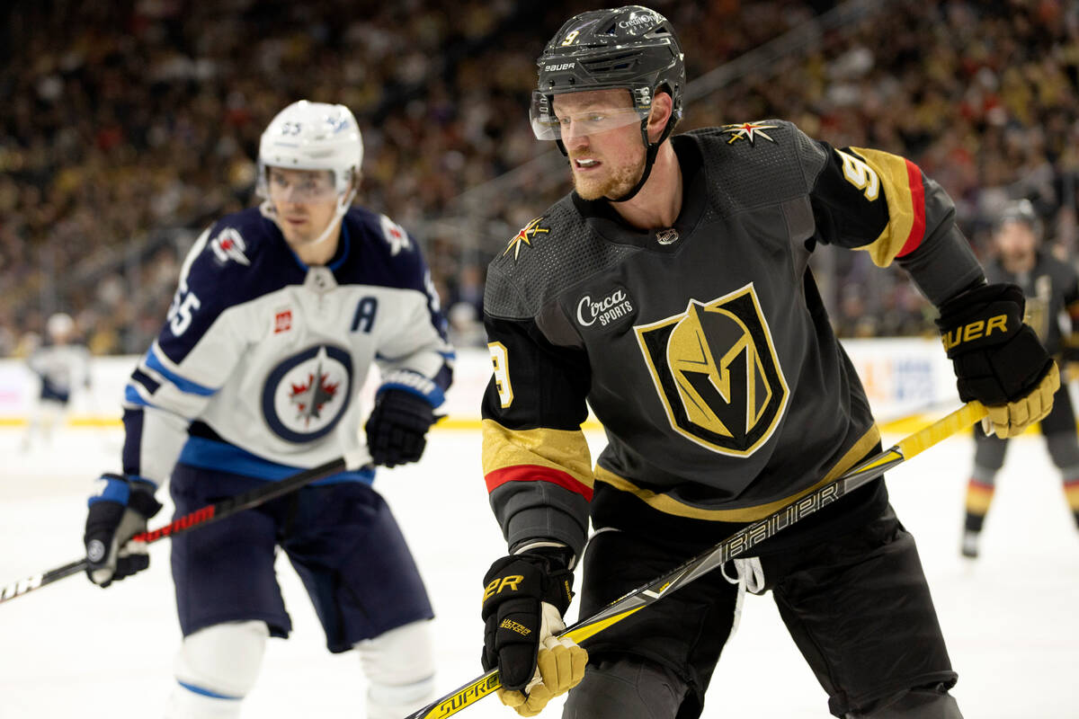 Vegas Golden Knights center Jack Eichel (9) and Winnipeg Jets center Mark Scheifele, left, watc ...