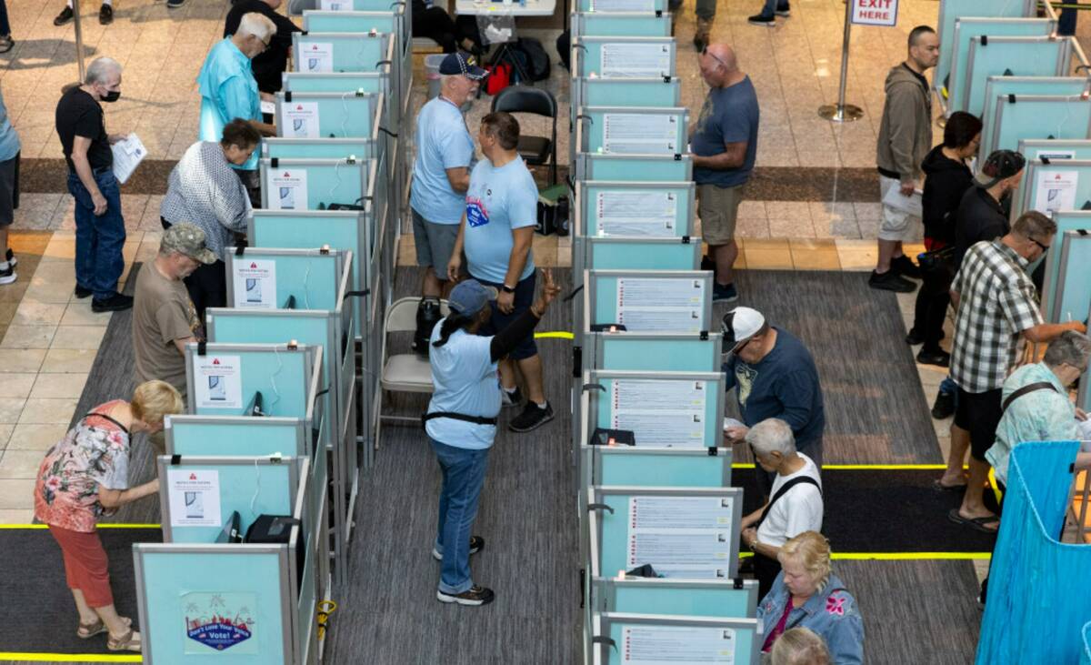 People cast their votes at the polling place inside of the Galleria At Sunset shopping mall in ...