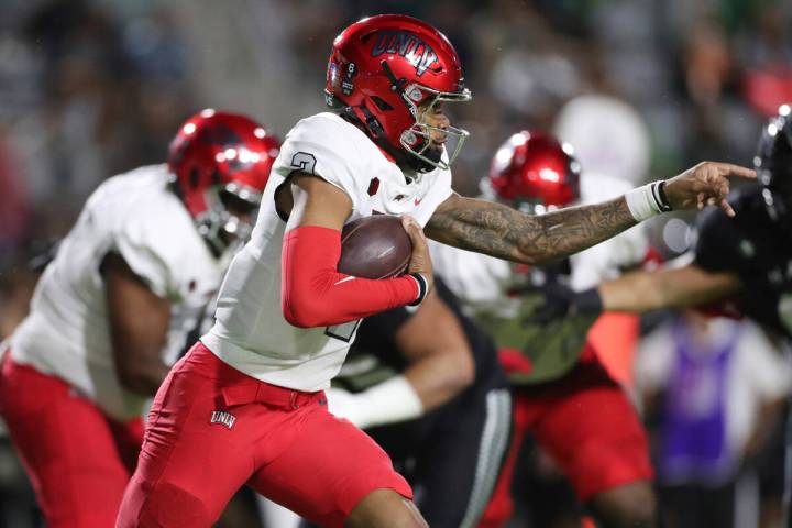 UNLV quarterback Doug Brumfield (2) carries against Hawaii during the first half of an NCAA col ...