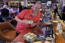 Jerrad Johnson celebrates a 7-spot hit on Four Card Keno for $140,000 at&#x ...