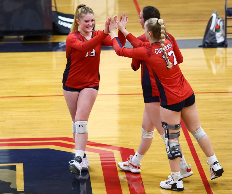 Coronado's Abigail Paulson (13) high-fives Angelina Sayles (17) during a volleyball game agains ...