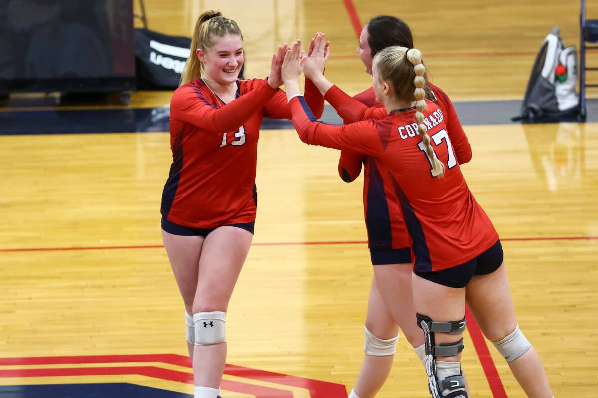 Coronado's Abigail Paulson (13) high-fives Angelina Sayles (17) during a volleyball game agains ...