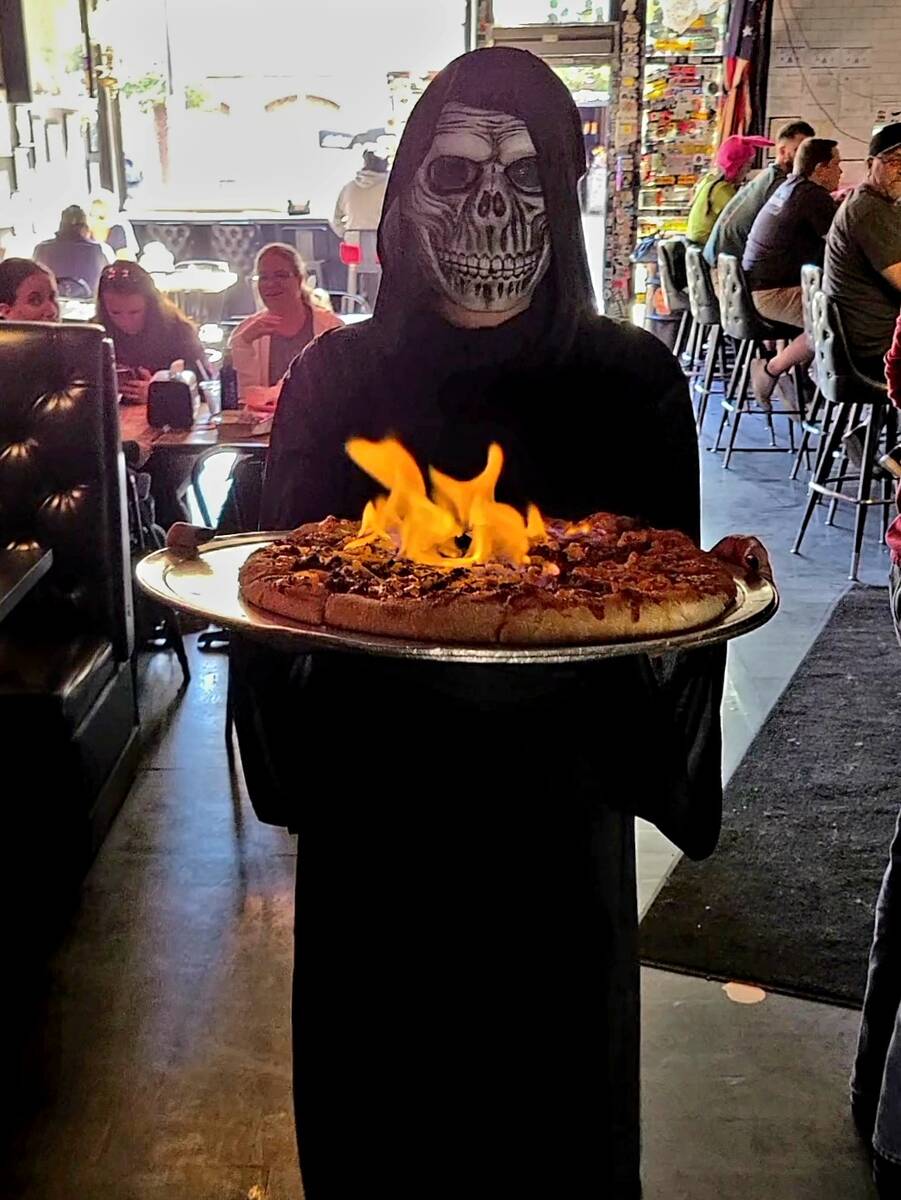 The Reaper delivers his namesake pizza at Evel Pie pizzeria in downtown Las Vegas. The pie is s ...
