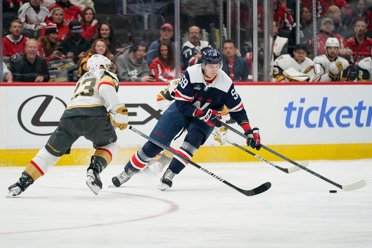 Washington Capitals center Aliaksei Protas, right, moves the puck past Vegas Golden Knights def ...