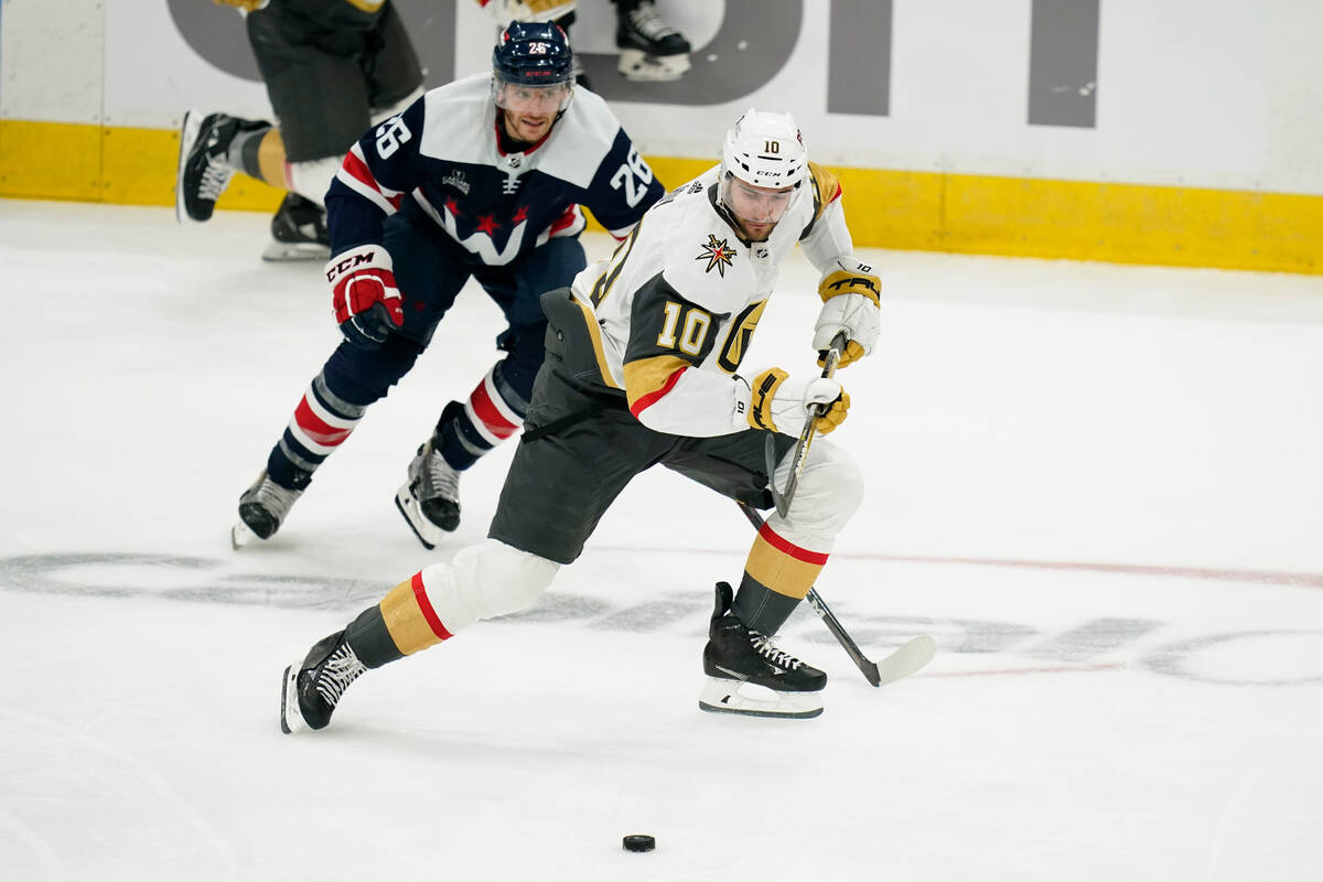 Vegas Golden Knights center Nicolas Roy (10) moves the puck past Washington Capitals center Nic ...