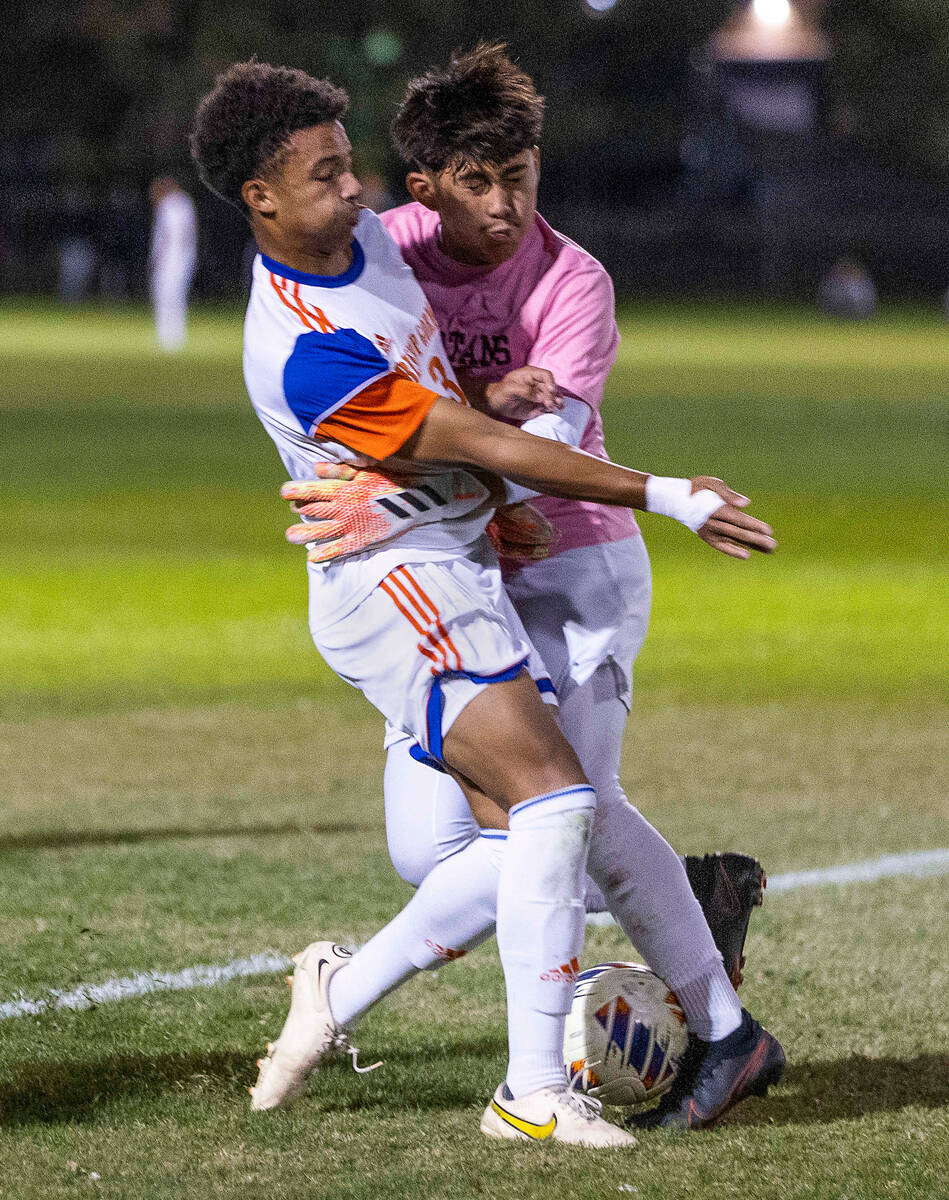 Bishop Gorman's Bronson Rolley (3) crashes into Cimarron's goalie RJ Murillo (1) on a scoring a ...