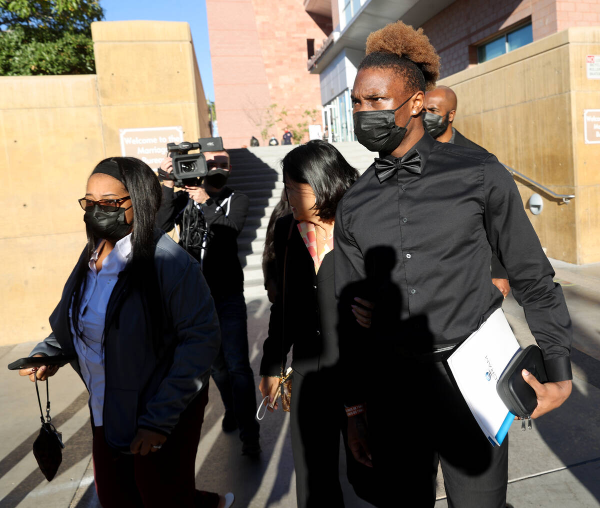 Henry Ruggs, right, walks out of the Regional Justice Center in Las Vegas on Nov. 22, 2021, wit ...