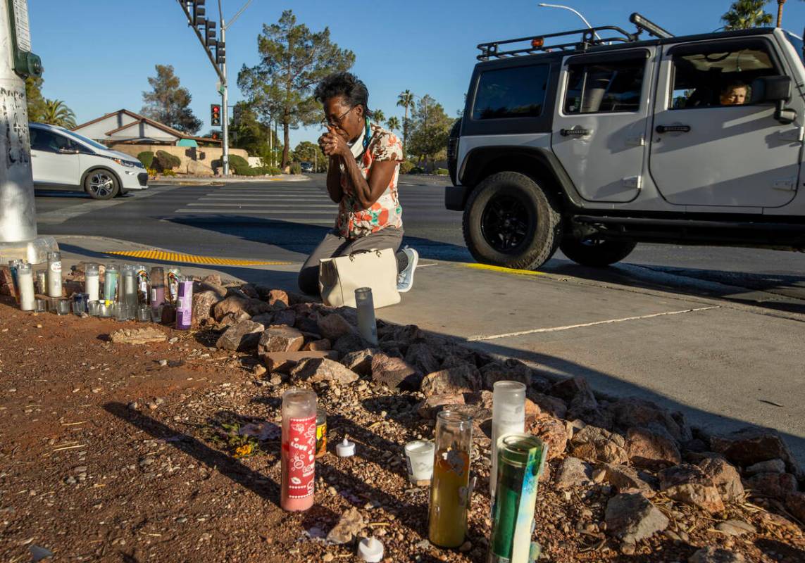 Renee Jimenez prays after lighting a candle at a roadside memorial for Tina Tintor on Nov. 4, 2 ...