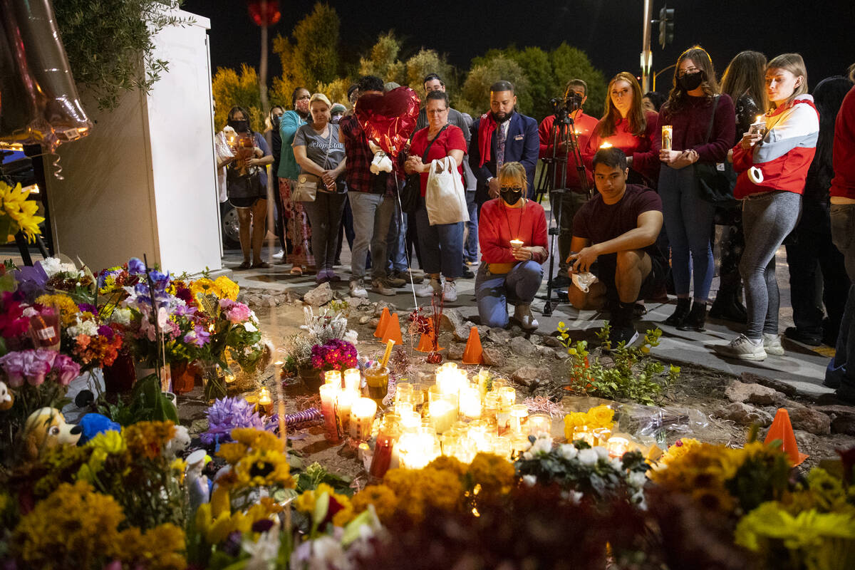 People attend a vigil for Tina Tintor and her dog, Max, at a memorial on Rainbow Boulevard and ...