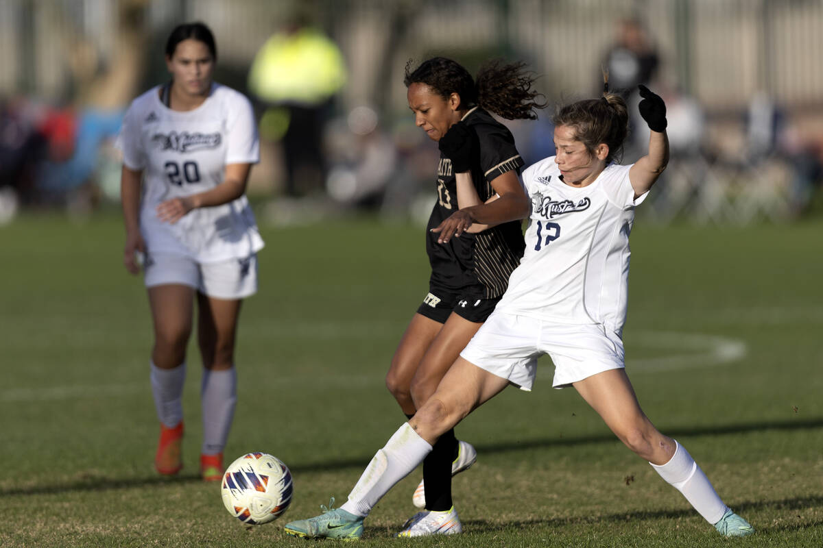 Shadow Ridge’s Loegan Alia (12) steals possession from Faith Lutheran’s Gabriella ...