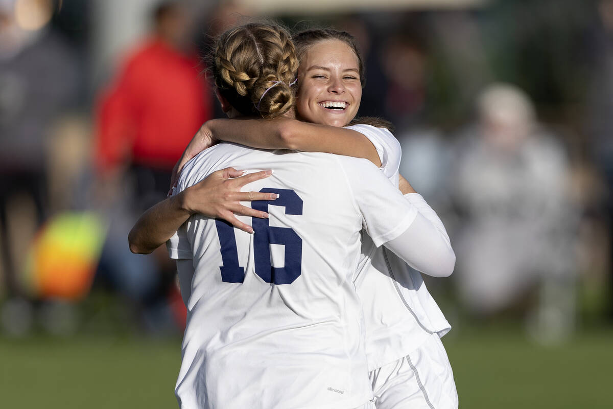 Shadow Ridge’s Meghan Wilhite (16) hugs Brynn Belcher (7) after Belcher scored a goal du ...