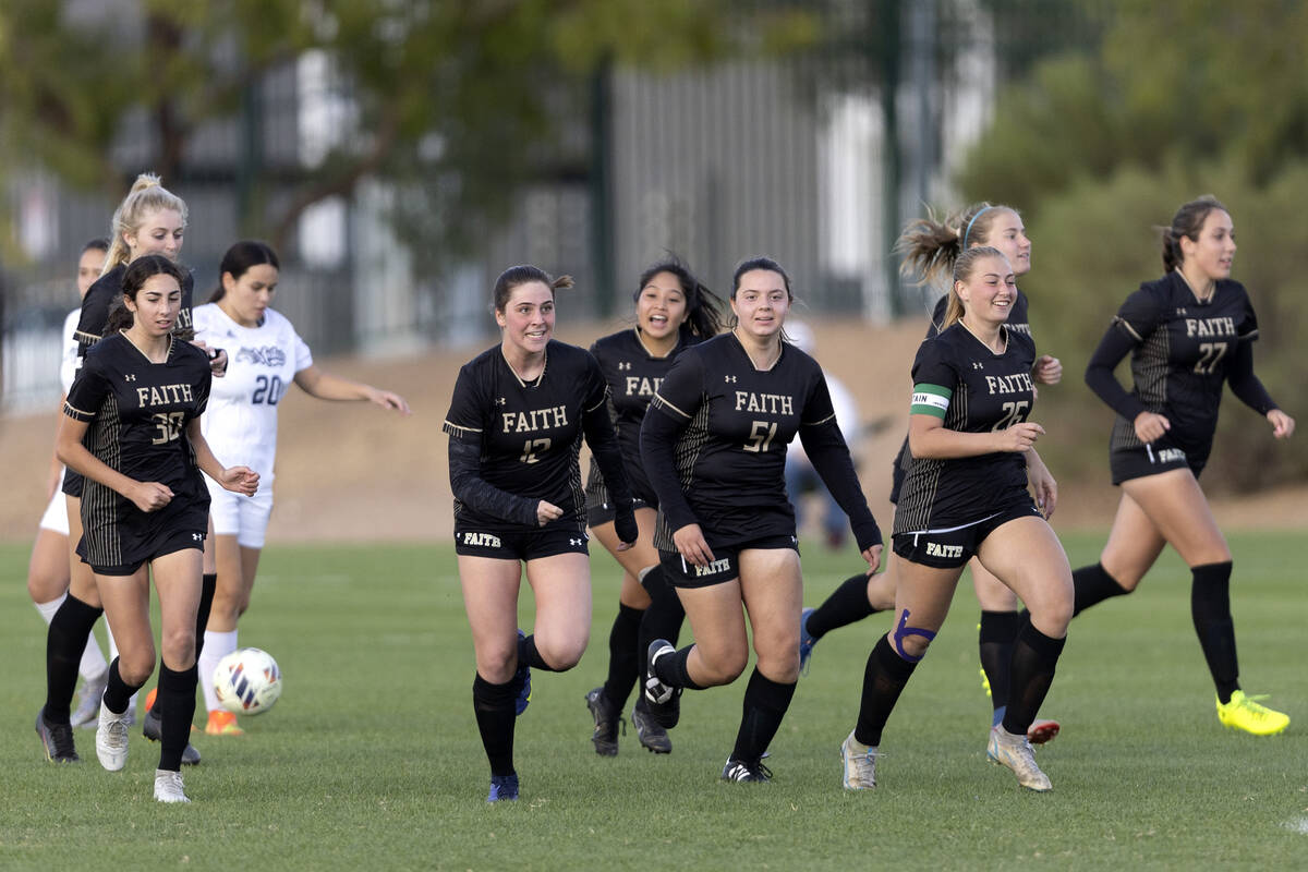 Faith Lutheran runs back into play after celebrating a goal during a Class 5A girls soccer regi ...