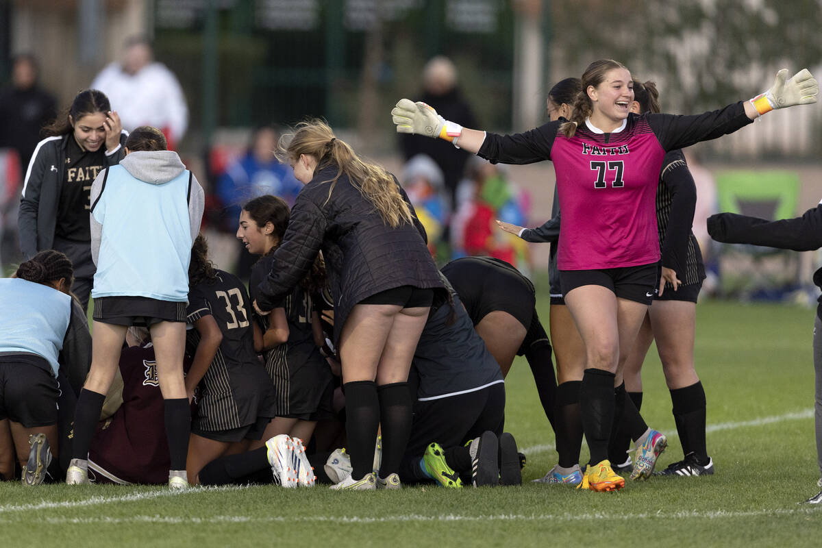 Faith Lutheran, including goalkeeper Elke Travis (77), celebrate after winning a Class 5A girls ...