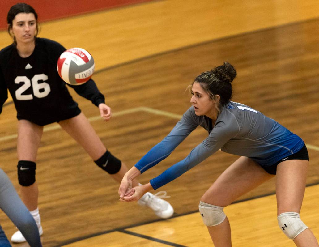 Basic’s Annamaria Ramos, right, reaches to bump while Riley Maroushek (26) watches durin ...