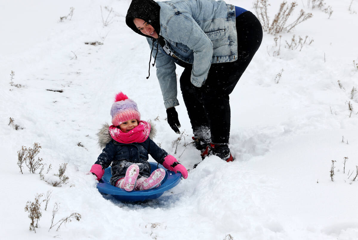 Angel Frias-Irizarry, 3, and he mom Angie Frias-Irizarry play in freshly fallen snow, in Upper ...