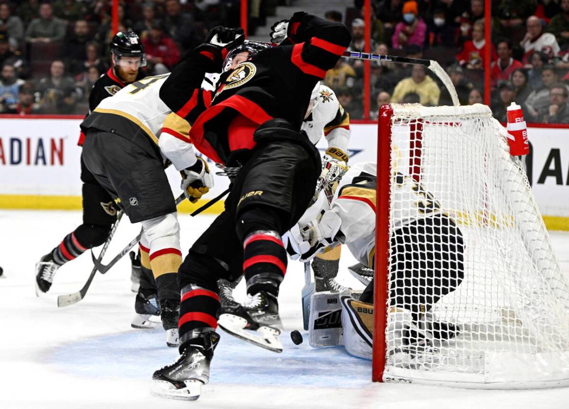 Ottawa Senators left wing Brady Tkachuk (7) falls after attempting a shot by skating through th ...