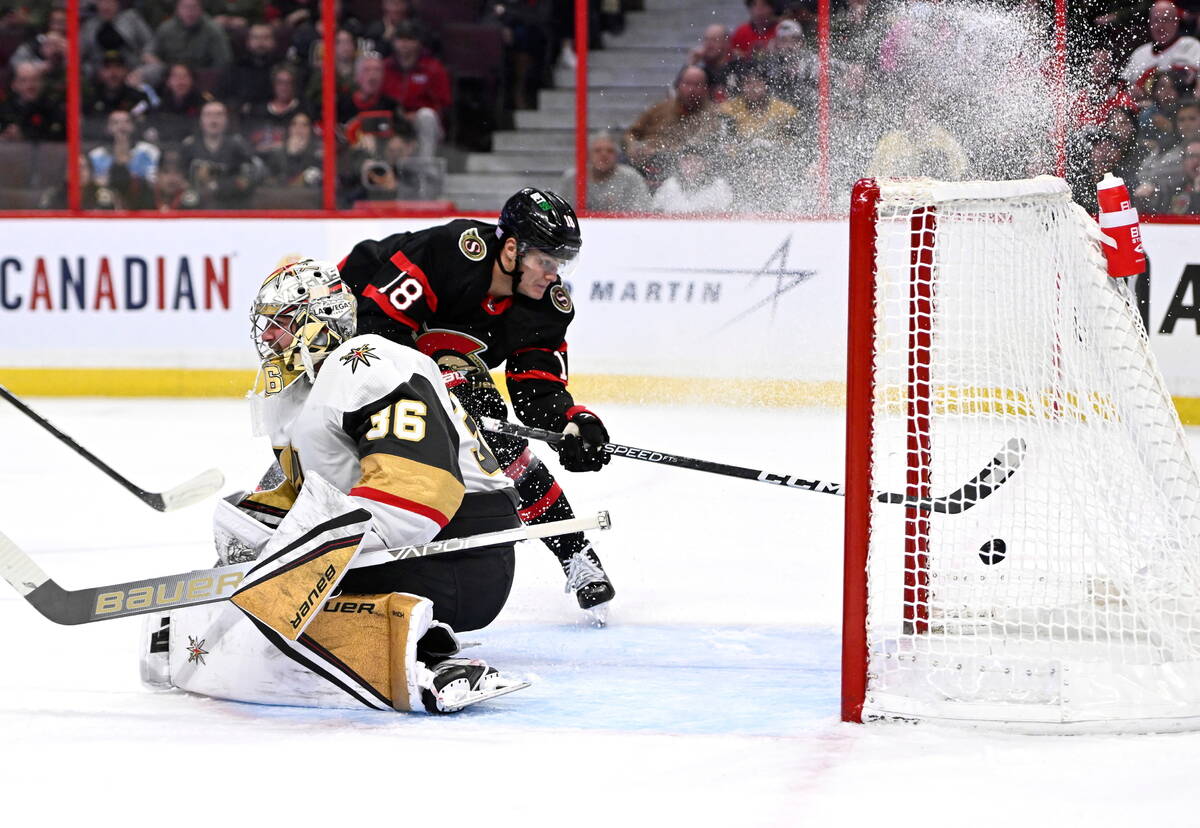 Ottawa Senators left wing Tim Stutzle (18) puts the puck in the net behind Vegas Golden Knights ...