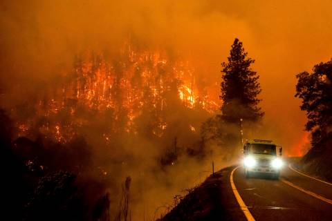 A firetruck drives along California Highway 96 as the McKinney Fire burns in Klamath National F ...