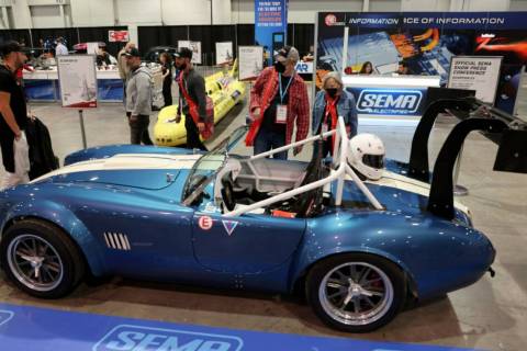 Michael and Nadine Skougard of Pueblo, Colo. check out an all electric AC Cobra based on the 19 ...