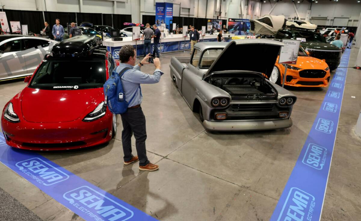 Keith Lutgen of Minneapolis takes a photo of a fully electric 1958 Chevy Apache in the SEMA Ele ...