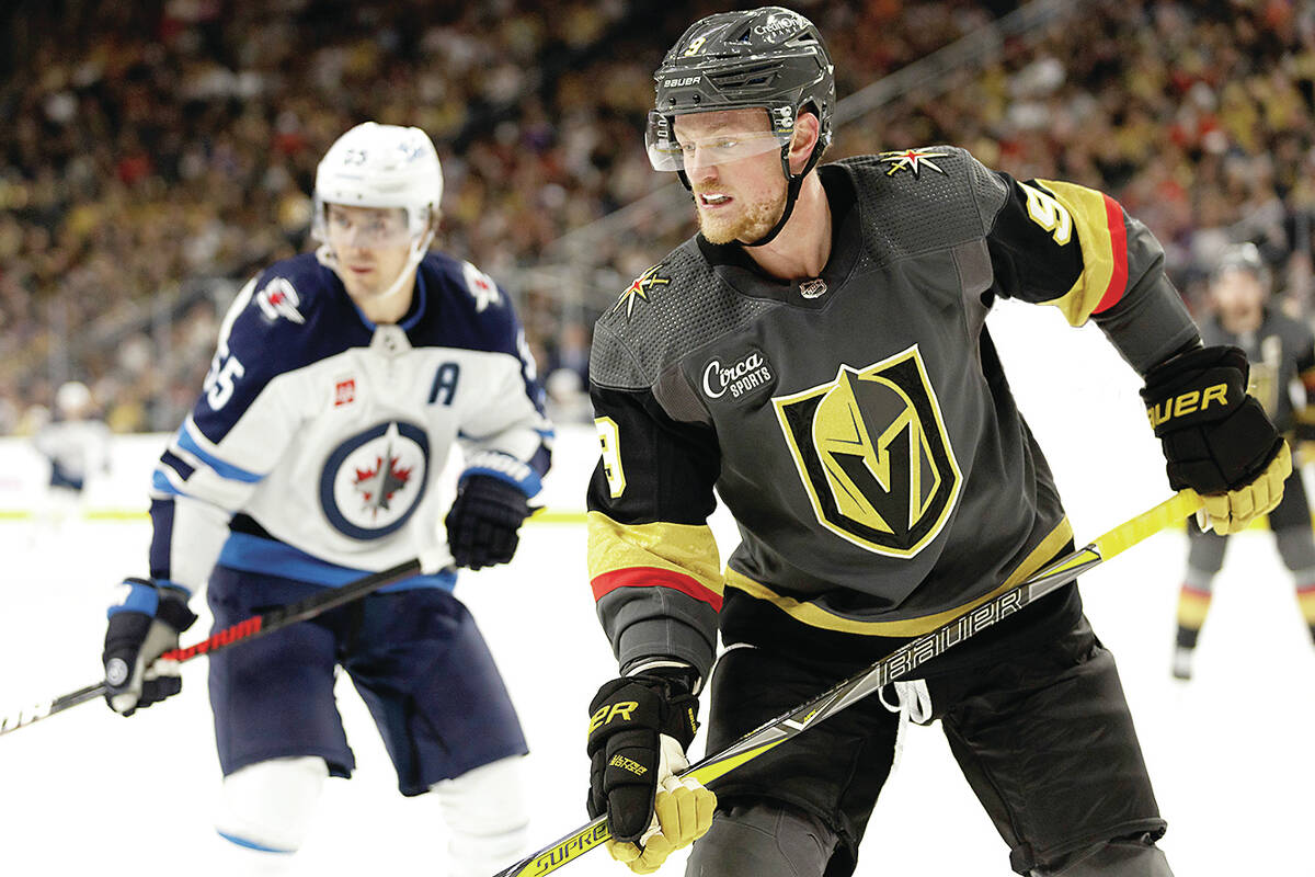 Vegas Golden Knights center Jack Eichel (9) and Winnipeg Jets center Mark Scheifele, left, watc ...