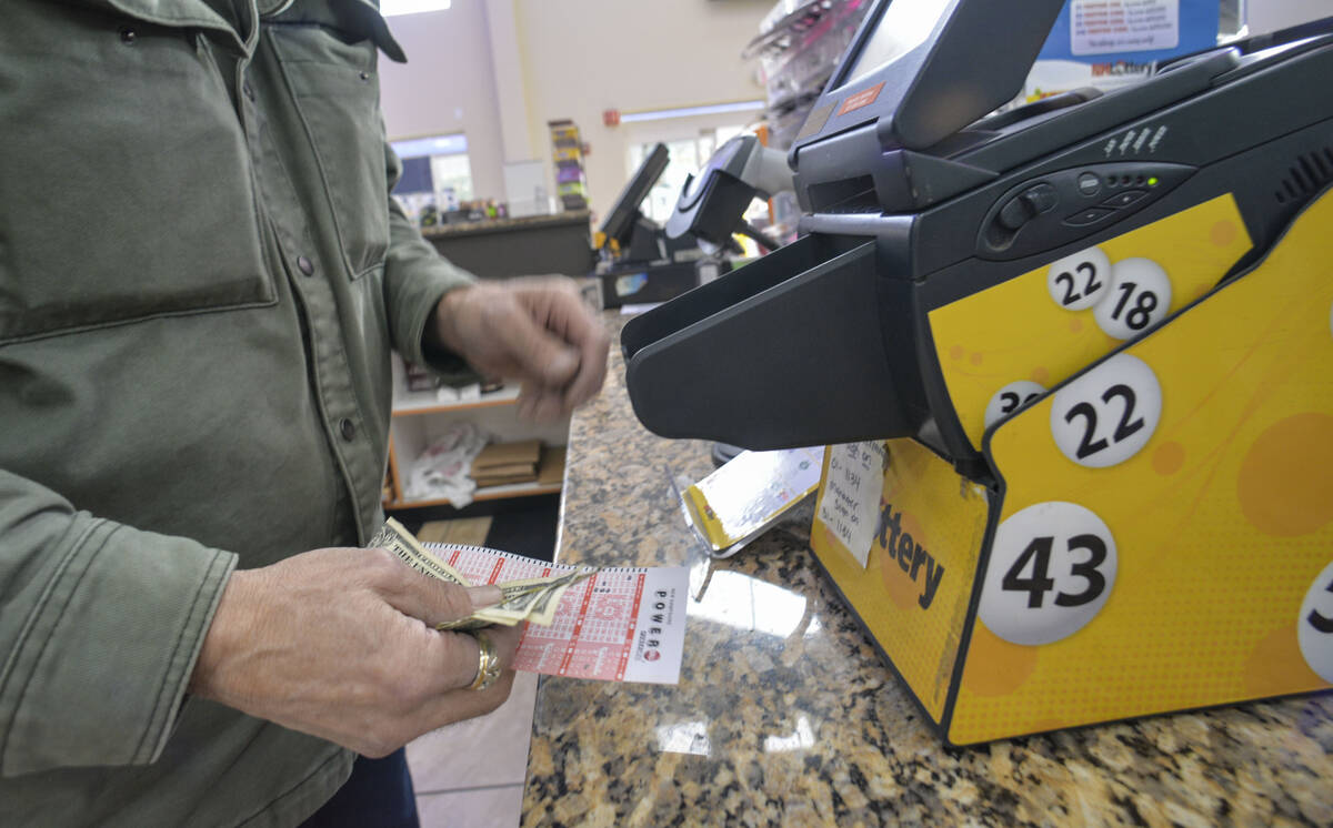 Bruce Gideos, floor manager at Pierre's Place, in Chesterfield, N.H., prints out Powerball tick ...