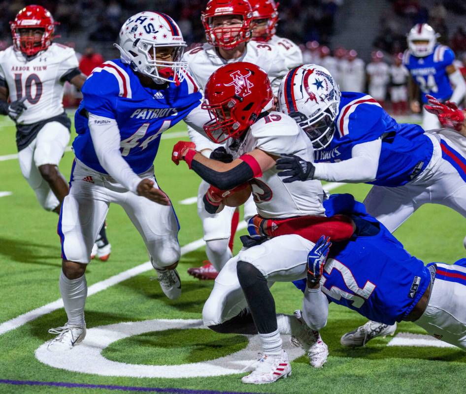 Arbor View returner Sean Griese (13) is tackled by Liberty OLB Melvin Whitehead (52) and SS Tyl ...