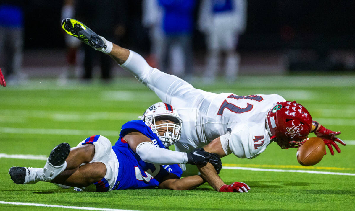 Arbor View MLB Christian Thatcher (42) dives for a fumble as Liberty RB Isaiah Lauofo (3) holds ...