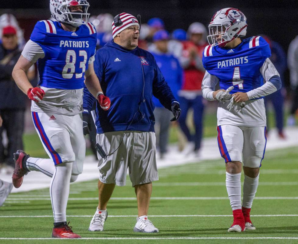 Liberty Head Coach Richard Muraco, center, calls a play with WR Colin Gregorio (4) versus Arbor ...