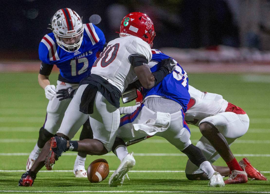 Arbor View defender Laron Atkins (10) attempts to keep Liberty players from recovering a fumble ...