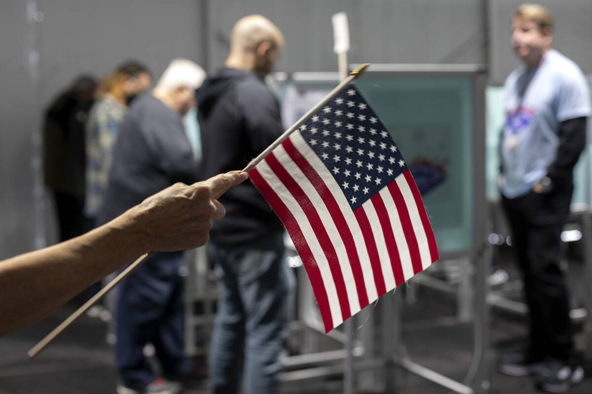 An election volunteer directs voters on the last day of early voting, Friday, Nov. 4, 2022, at ...