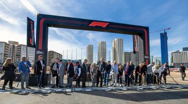 Formula One Las Vegas Grand Prix dignitaries and guests push rollers during a start/finish line ...
