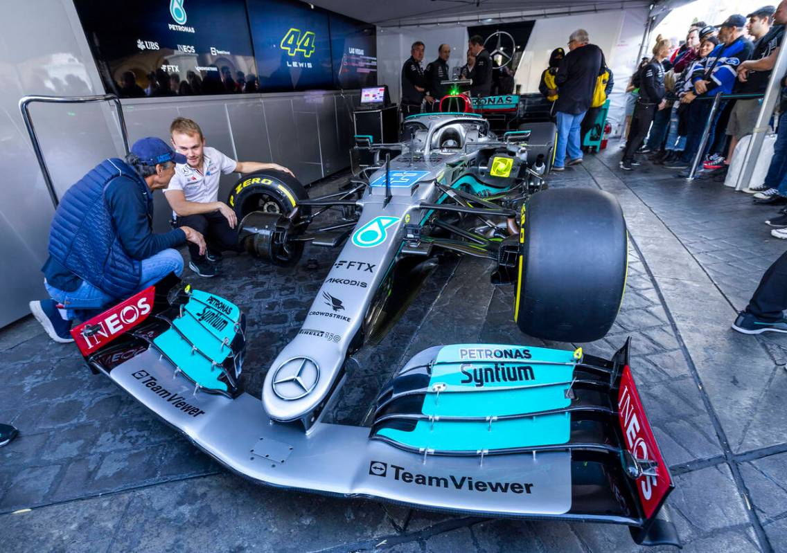 A team technician shows off the Lewis Hamilton – Mercedes-AMG Petronas racing car during ...
