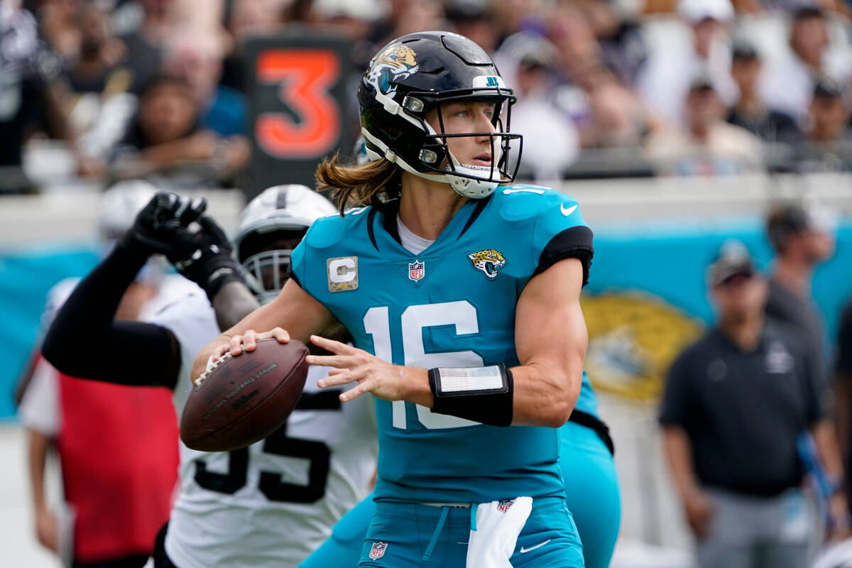 Jacksonville Jaguars quarterback Trevor Lawrence passes against the Las Vegas Raiders in the fi ...