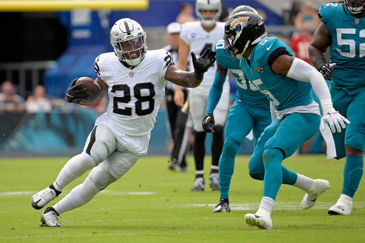 Las Vegas Raiders running back Josh Jacobs (28) tries to get past Jacksonville Jaguars safety A ...