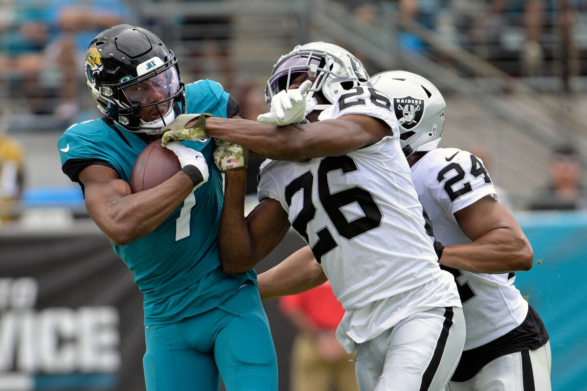 Jacksonville Jaguars wide receiver Zay Jones (7) is stopped by Las Vegas Raiders cornerback Roc ...