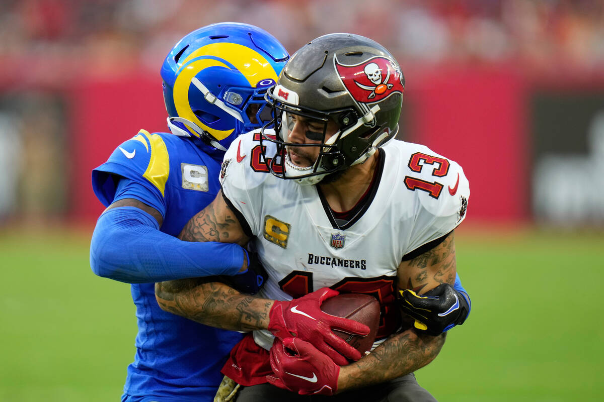 Tampa Bay Buccaneers wide receiver Mike Evans (13) is stopped by Los Angeles Rams cornerback Ja ...