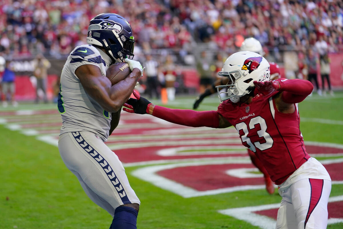 Seattle Seahawks wide receiver DK Metcalf, left, catches a touchdown pass against Arizona Cardi ...